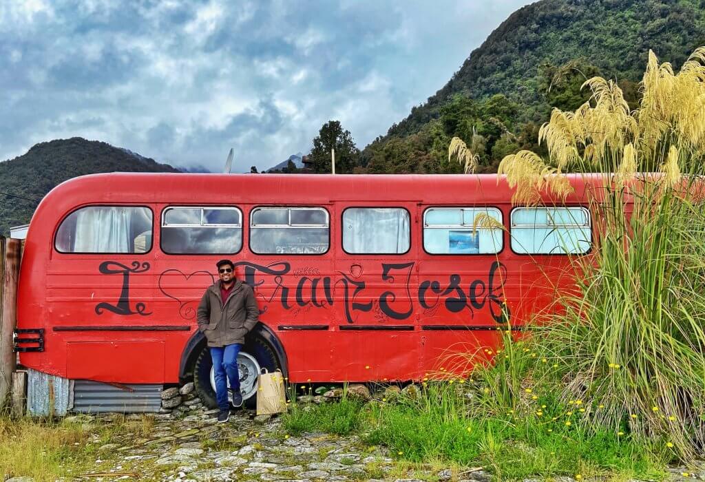 Graffiti saying 'I Love Franz Josef' on an abandoned bus at Franz Josef Town, New Zealand