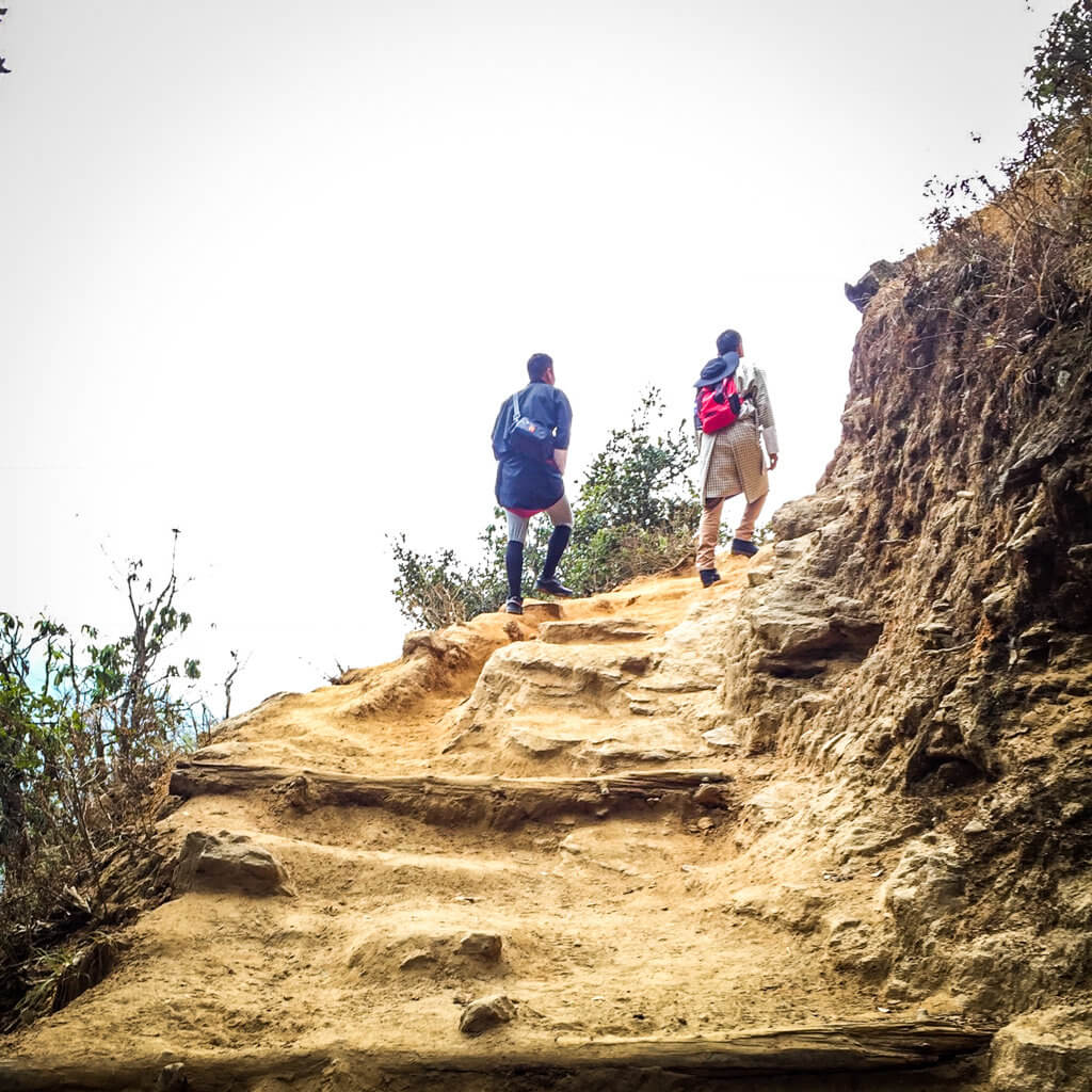 How to Reach Paro Taktsang? Via a Dirt Trail in the Mountains.