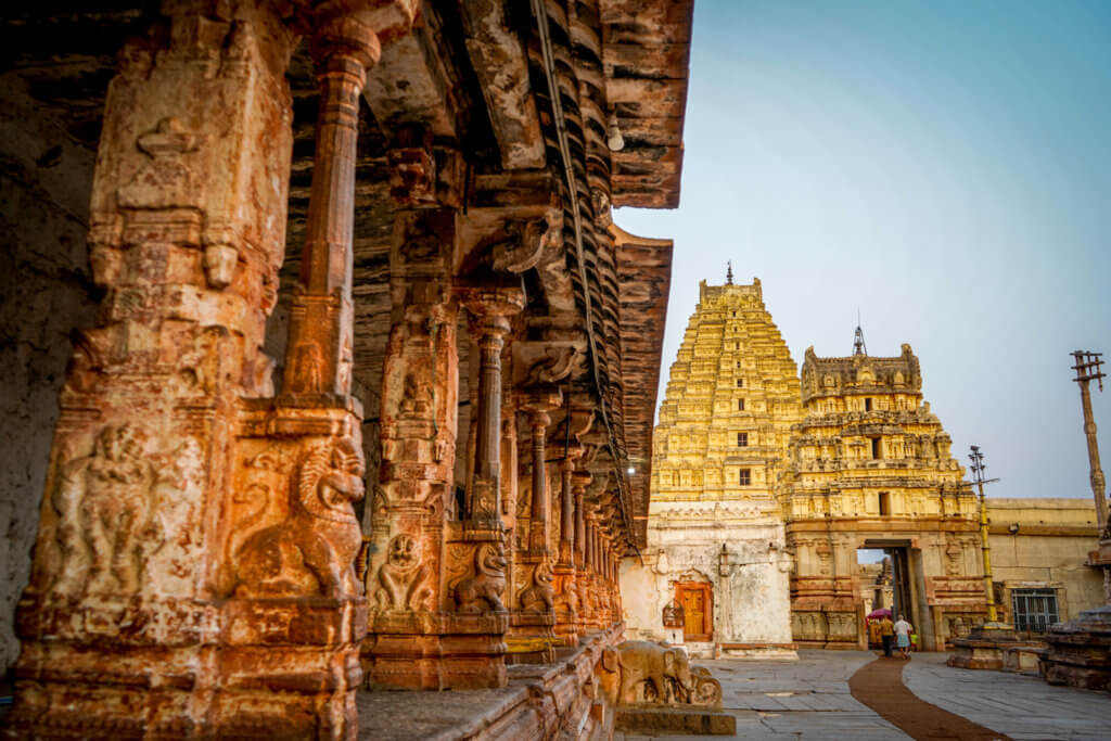 The twin gopurams and ornate pillars of Virupaksha Temple from the inside