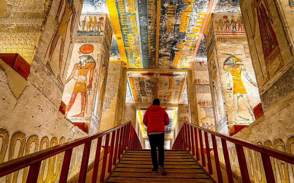A man walking in the colorful tombs in Egypt