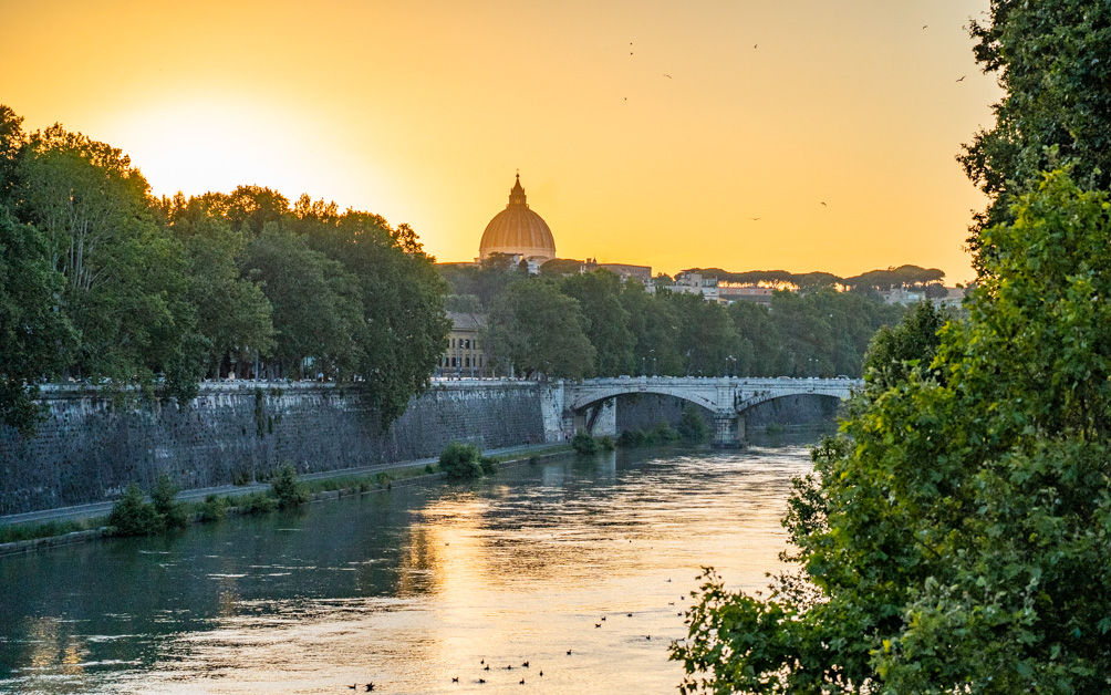 The view of the Tiber and St. Peter's Basilica from Ponte Sisto at sunset