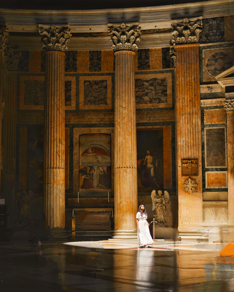 Girl observing the beam of light inside the the Pantheon in Rome