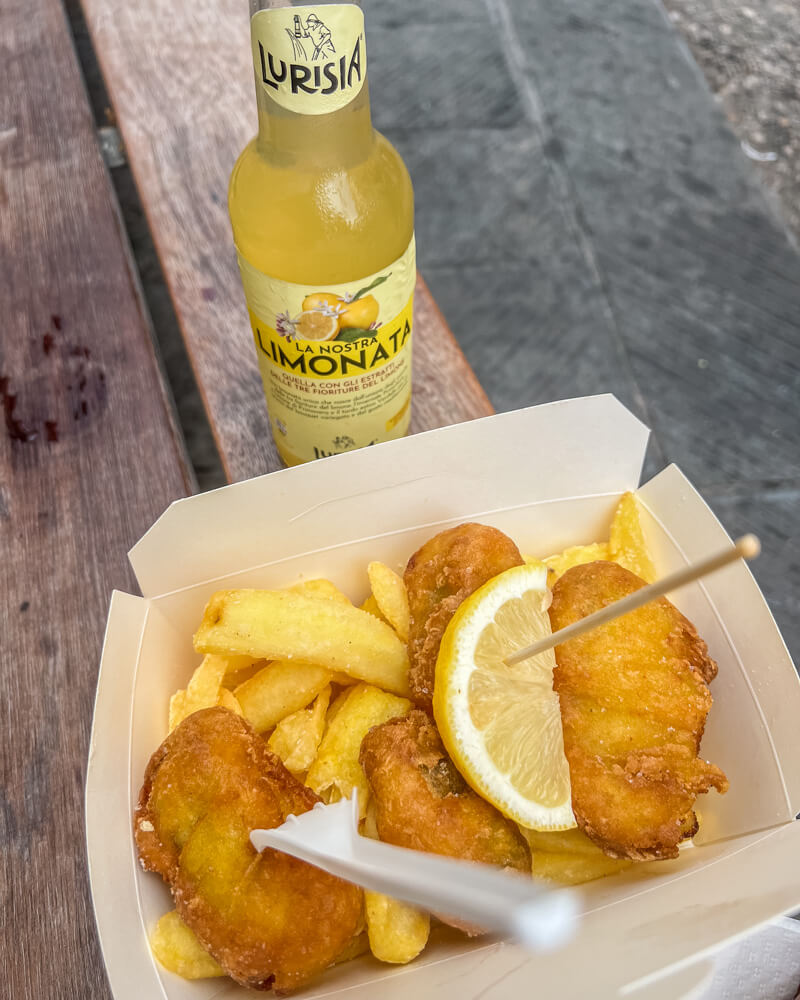 Having fish and chips and lemonade from Tutti's
