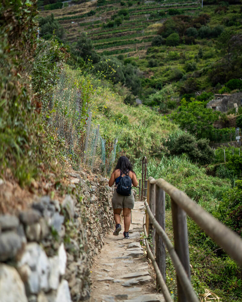 A girl in shorts hiking in Cinque Terre 