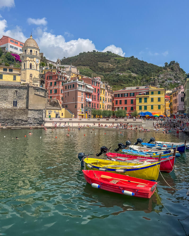 The stunning waterfront at Vernazza with colourful houses and boats - a must-see if you're spending one day in Cinque Terre