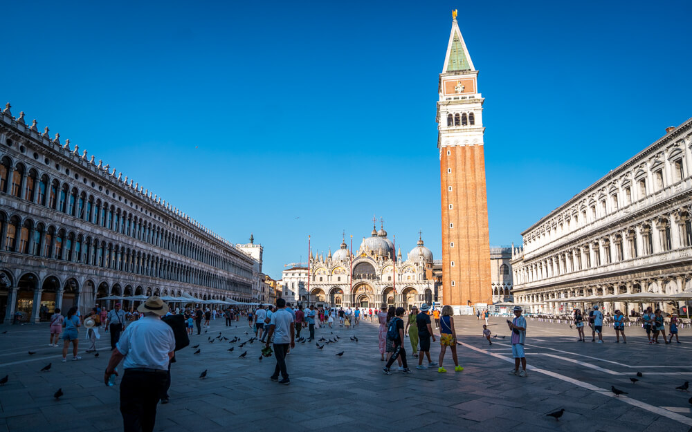 The busy St. Mark's Square in Venice with a view of the campanile, St. Marks Basilica and government buildings