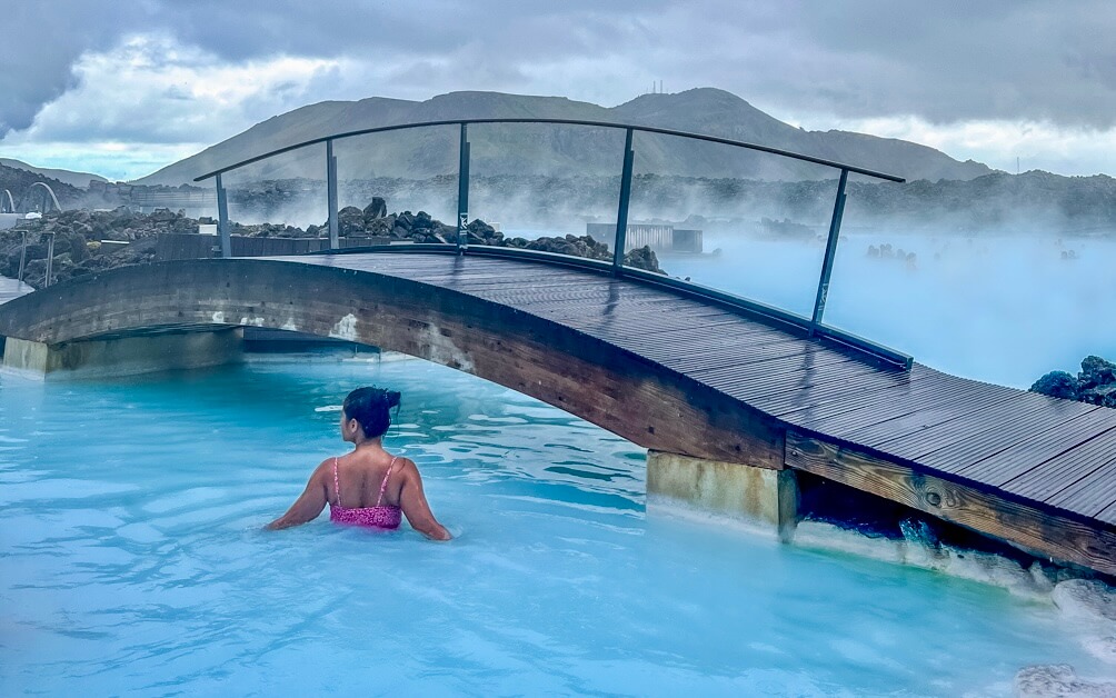 10-Day Iceland Itinerary: An Unforgettable Road Trip 11 A girl enjoying the Blue Lagoon in Iceland following this 10-day iceland Itinerary