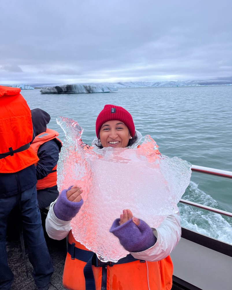 10-Day Iceland Itinerary: An Unforgettable Road Trip 37 A girl holding 1000-year-old ice on an Amphibian Boat Tour