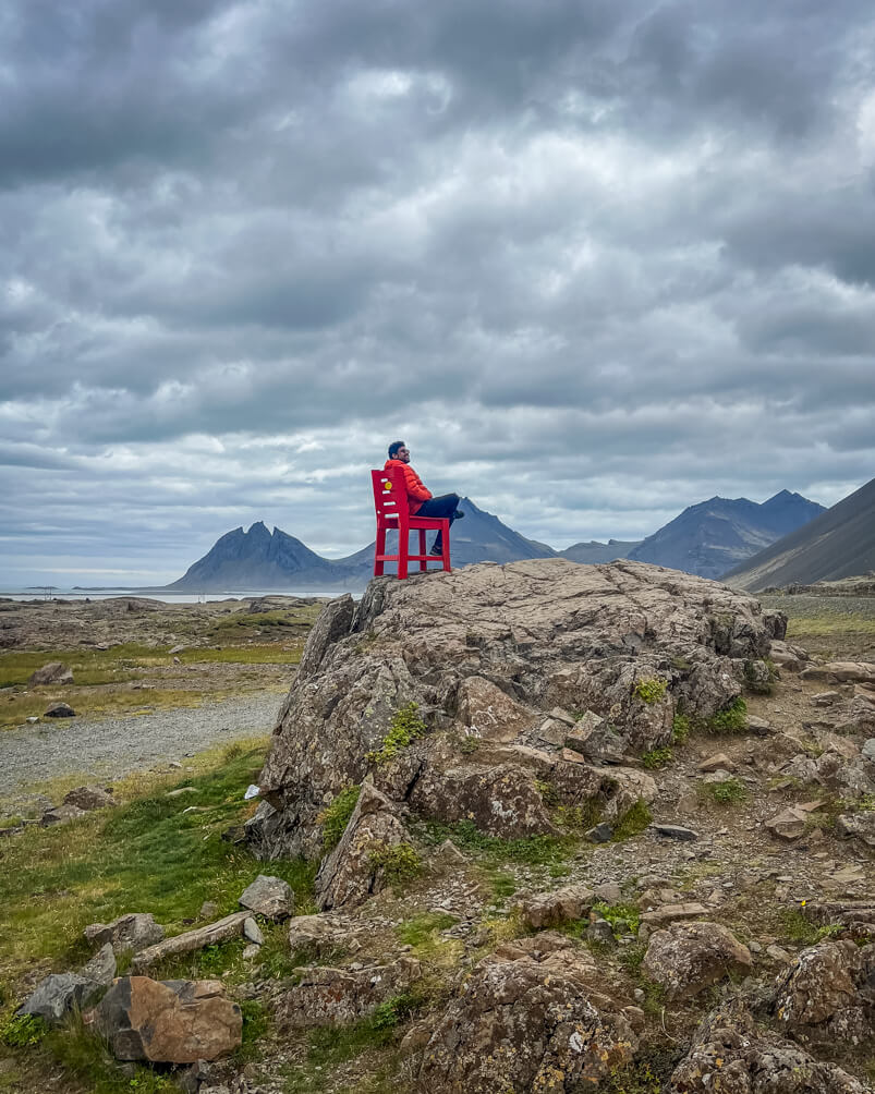 10-Day Iceland Itinerary: An Unforgettable Road Trip 42 A giant red chair in the middle of nowhere in Iceland with a gorgeous view of Vestrahorn of course