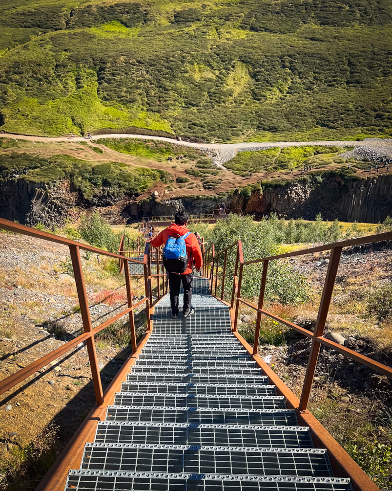 10-Day Iceland Itinerary: An Unforgettable Road Trip 47 Man climbing down the viewing platform on the west side of Studlagil