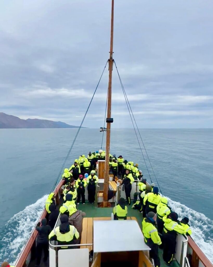 10-Day Iceland Itinerary: An Unforgettable Road Trip 54 Looking for whales wearing matching warm overalls on a whale watching tour in Husavik, Iceland.