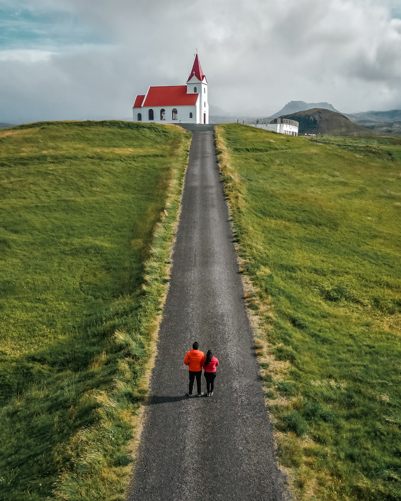 10-Day Iceland Itinerary: An Unforgettable Road Trip 59 The white and red Ingjaldshólskirkja Church as seen from the road leading up to it.