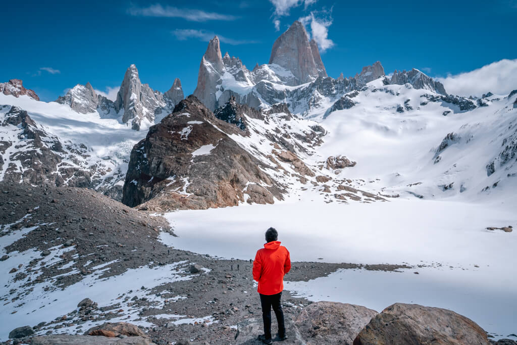 A man standing infront of Fitz Roy mountain in Argentina