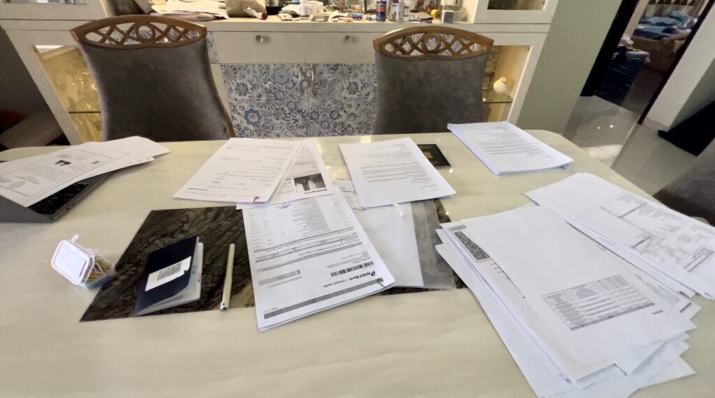 Documents for applying for a visa strewn on the table