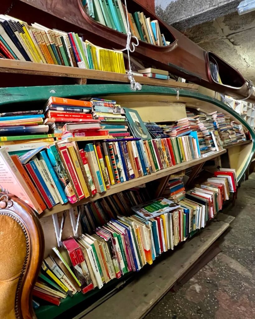 What to See in Venice in 2 Days: The Ultimate Itinerary 13 Books displayed in boats at Liberia Acqua Alta