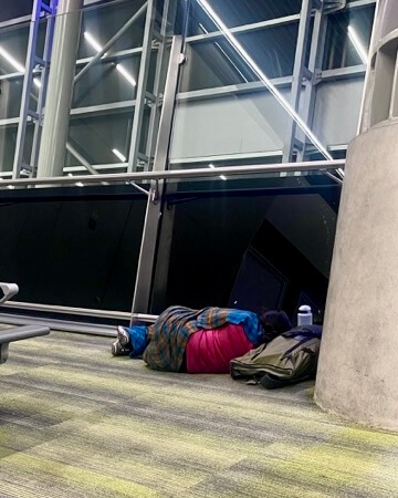Sleeping at the airport because of a flight cancellation during our world trip