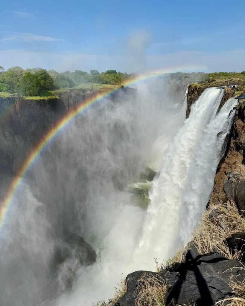 The Perfect 3 Days Victoria Falls Itinerary and Guide 16 The waterfall and rainbow with a peek into just how massive the falls is below the devil's pool.