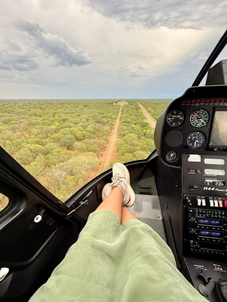 The Perfect 3 Days Victoria Falls Itinerary and Guide 20 A POV of a woman in a helicopter looking down at the vast bush below