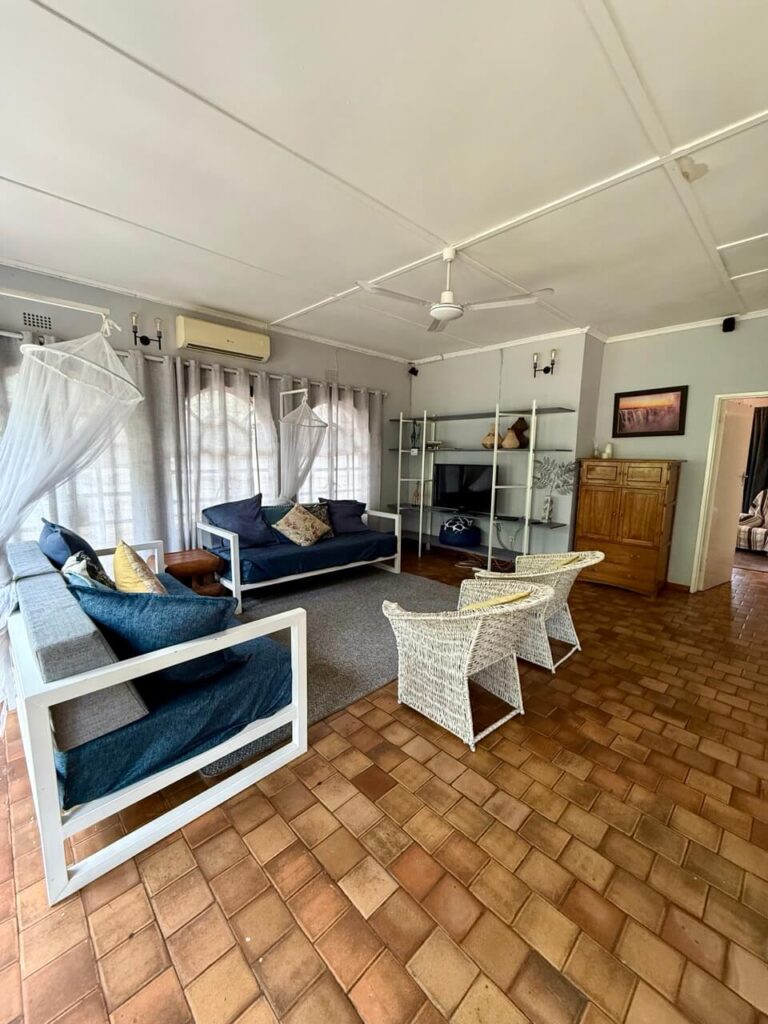 The Perfect 3 Days Victoria Falls Itinerary and Guide 7 The livingroom of our spacious Airbnb with large windows and comfy blue sofas