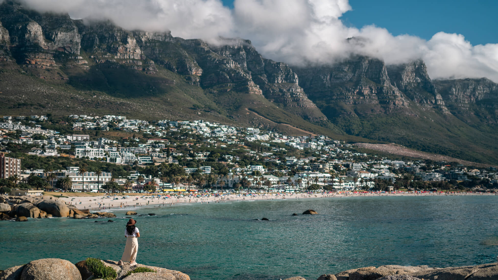 A girl looking at the beautiful 12 apostles mountains and the beach  in Cape Town, South Africa.