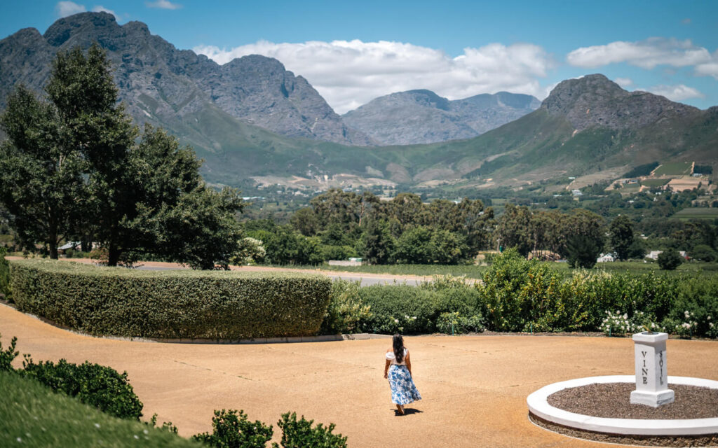 Is South Africa Safe to Travel? Honest Tips + Self-Drive vs Guided Trip 5 A gir walking while looking at mountains in the winelands in South Africa