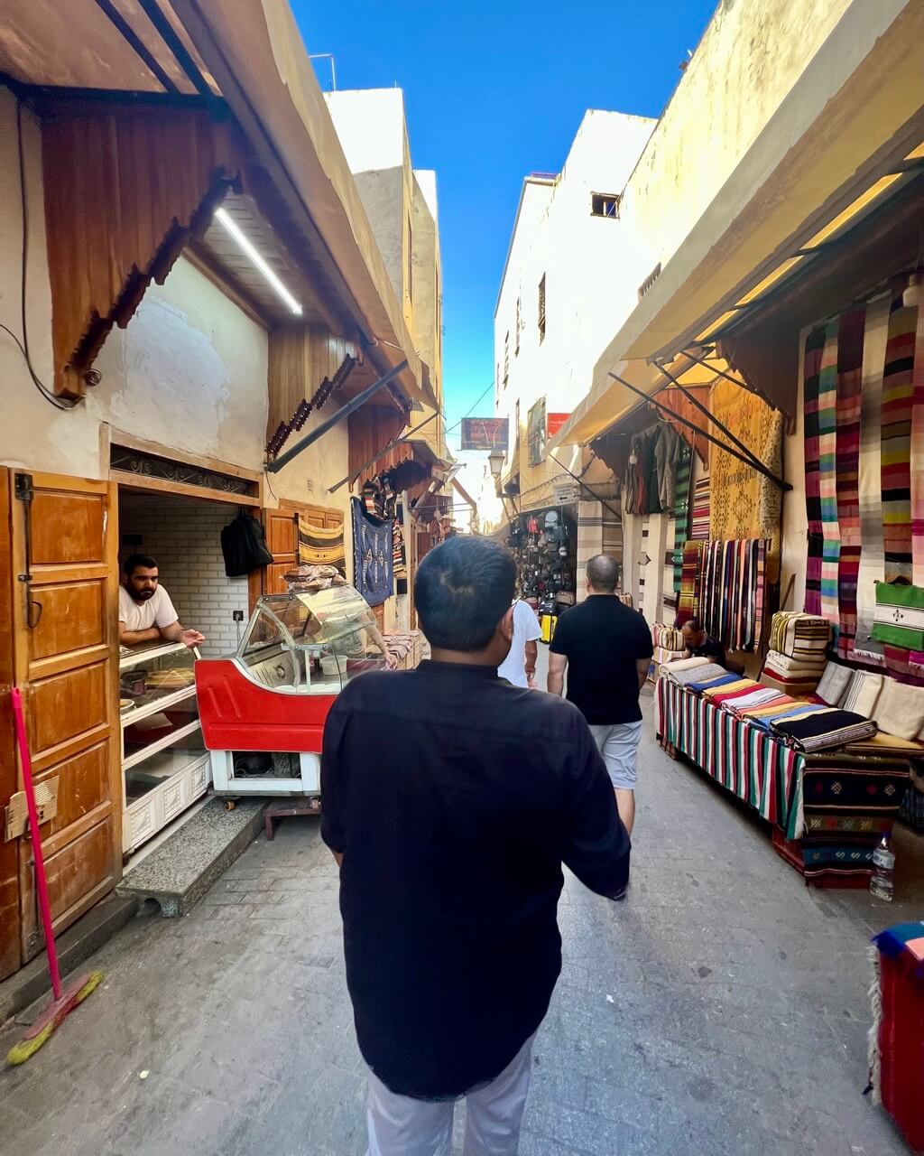 A bustling street in the Fes Medina, where driving can be tricky due to narrow lanes and heavy foot traffic. Renting a car in Morocco is convenient, but some areas are best explored on foot.