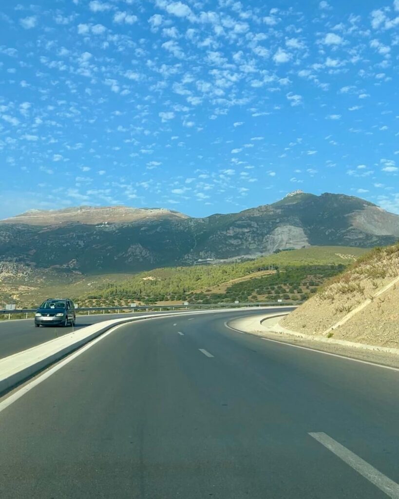 Driving in Morocco: Tips, Scams & What No One Tells You 7 A winding road in the mountains and blue skies