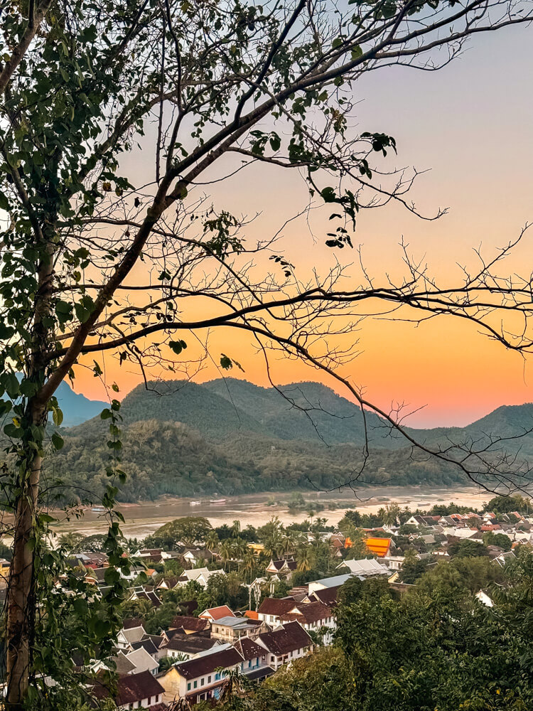 The Only Laos Itinerary You Need for 1 Week in Laos 20 This is a view of the Mekong River, the mountains and the city of Luang Prabang at sunset as seen from Phousi Hill