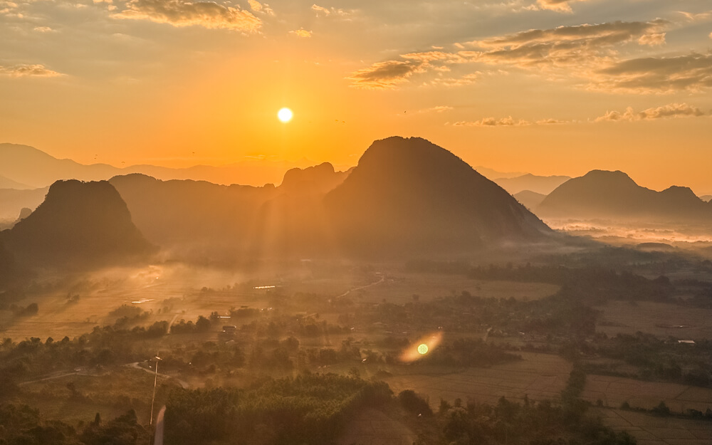The Only Laos Itinerary You Need for 1 Week in Laos 10 A view of the mountains and misty fields of Vang Vieng at sunrise