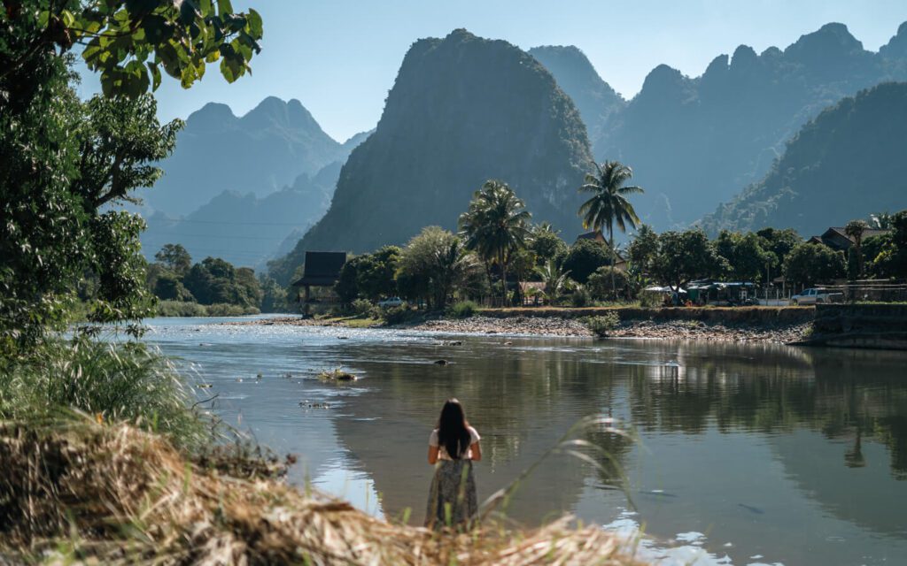 A girl looking at the view of the mountains and river near Vang Vieng in Laos