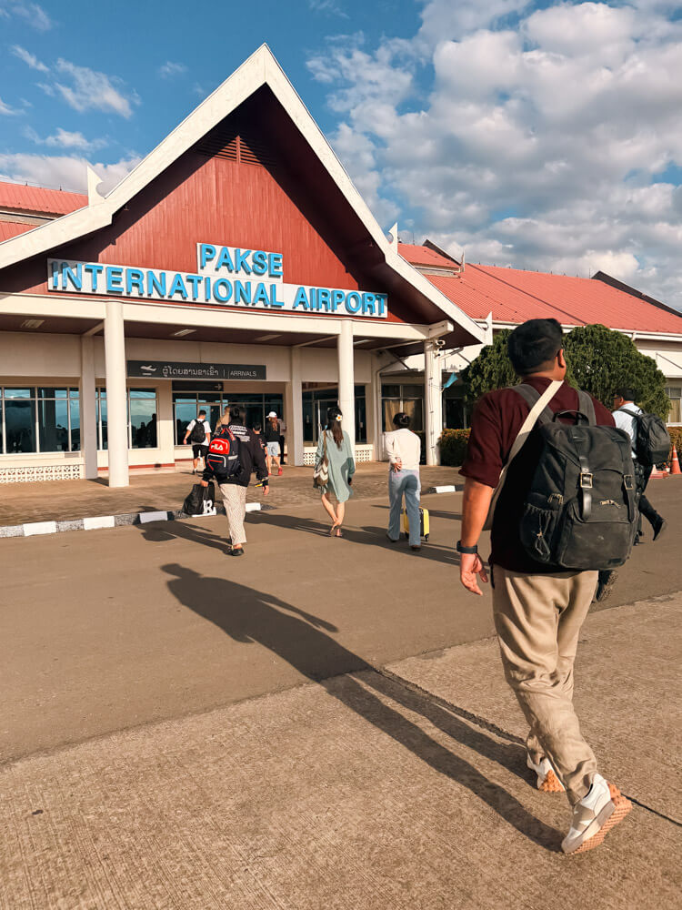 Is Pakse Worth Visiting? 7 Reasons to Go & 3 to Skip It 5 People walking towards the terminal at Pakse International Airport