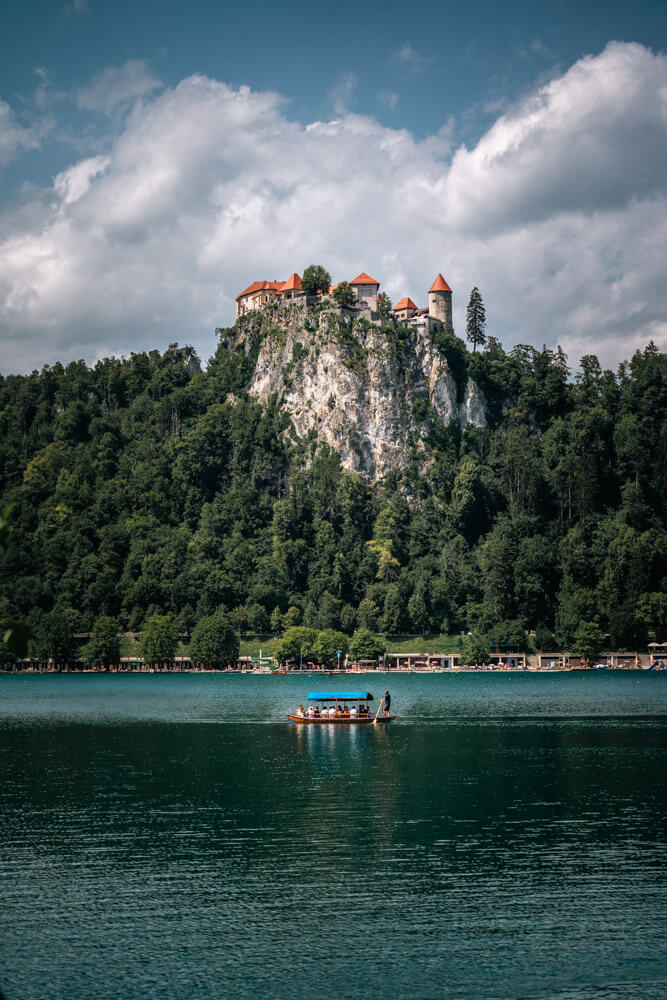 2-Day Lake Bled Itinerary: The Perfect Road Trip Guide 11 A view of Bled Castle and a Pletna Boat on the lake