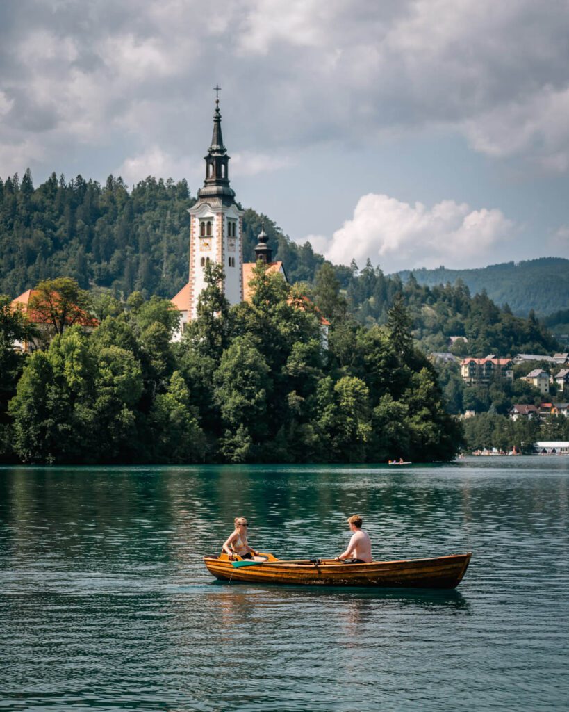 2-Day Lake Bled Itinerary: The Perfect Road Trip Guide 8 Boating on Lake Bled with a view of the church in the background