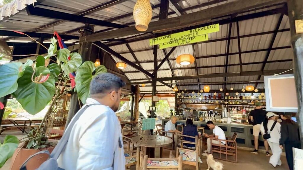 Is Pakse Worth Visiting? 7 Reasons to Go & 3 to Skip It 12 A man walking towards a cafe - Lak 40