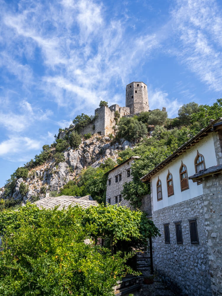 Day Trip to Mostar from Split or Dubrovnik (How to Plan It) 10 A view of a majestic fort perched on top of a hill with a beautiful blue sky in the background