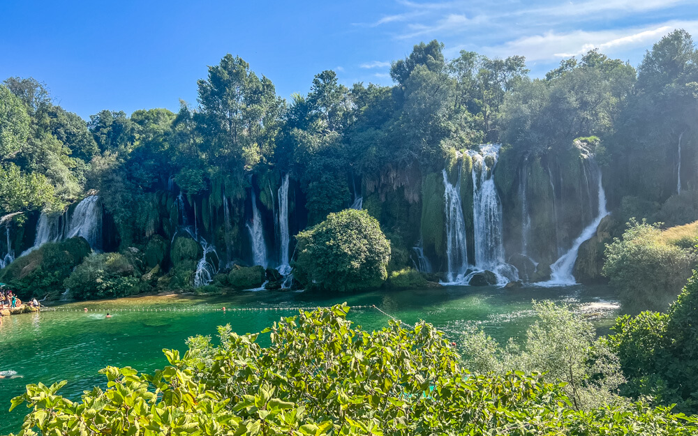 Day Trip to Mostar from Split or Dubrovnik (How to Plan It) 7 The beautiful emerald green waters and multiple cascades of Kravica Waterfall