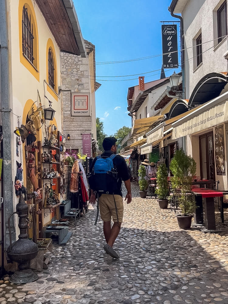 Day Trip to Mostar from Split or Dubrovnik (How to Plan It) 17 A man walks on the cobbled streets of Mostar on a day trip from Split