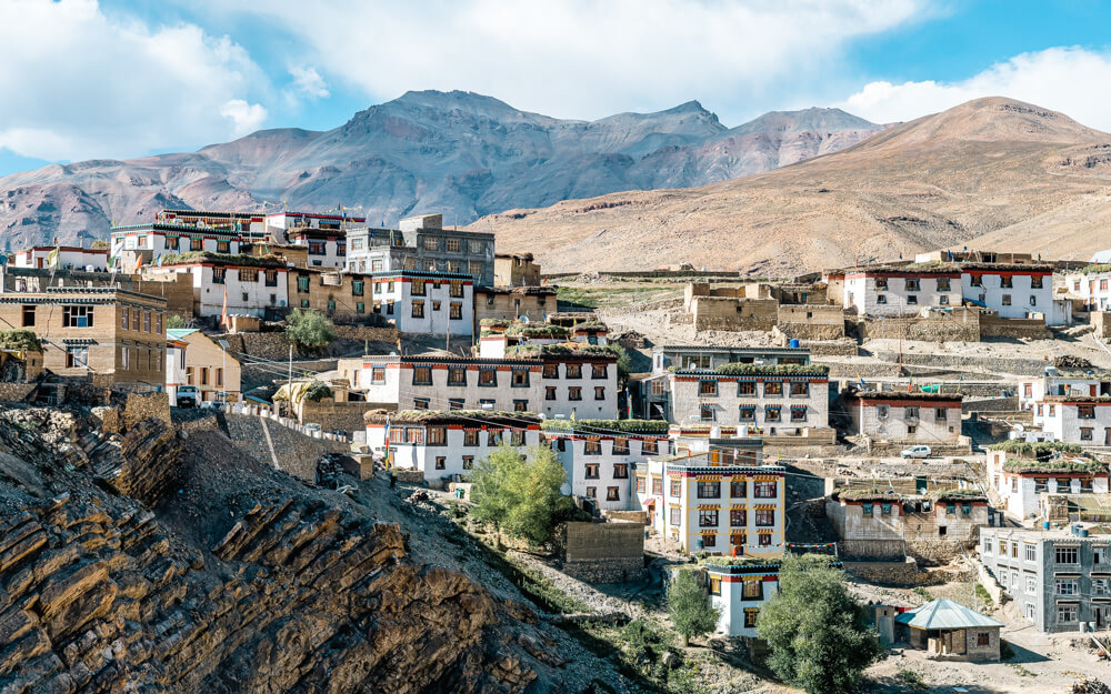 The Ultimate Spiti Valley Packing List for 2026 3 A panoramic view of Kibber village in the Spiti Valley with white houses made from stone, mud, and limestone.