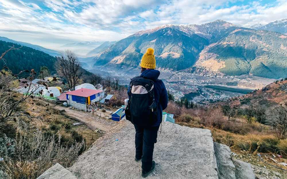 The Ultimate Spiti Valley Packing List for 2026 4 A person looks out at the scenery in Spiti wearing warm clothes that are essential in any Spiti Valley packing list