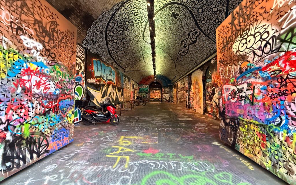Colourful graffiti inside Leake Street Tunnel, London's famous legal street art tunnel near Waterloo.