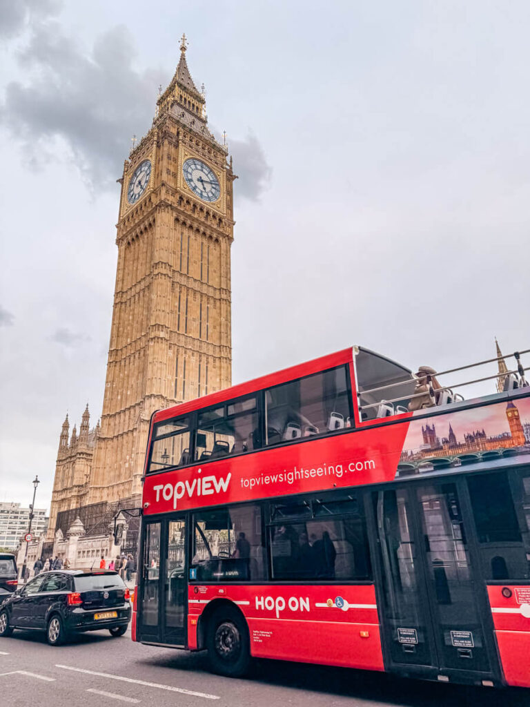 7 Best Paid Attractions in London Actually Worth Paying For 23 A photo of the Hop-on Hop-off Bus stuck in traffic in front of the Elizabeth tower (Big Ben) in London