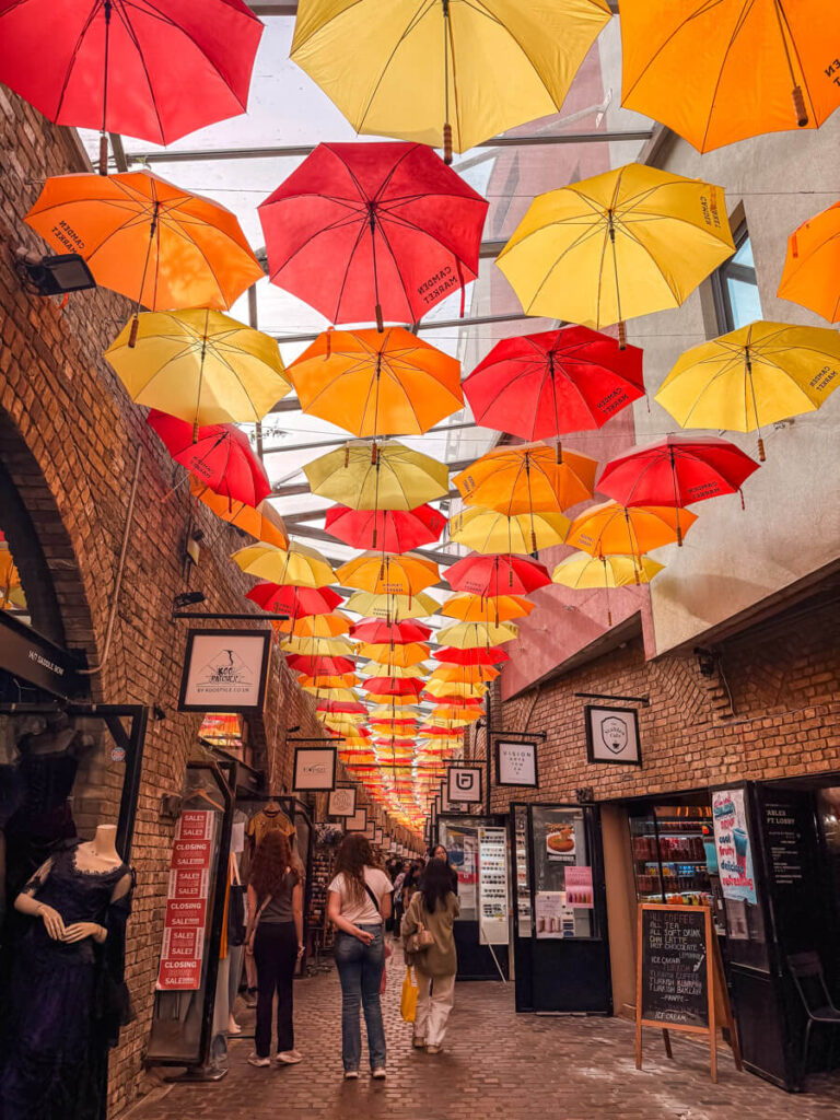 Colourful umbrellas and independent shops in Camden Market, London